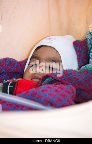 A baby in a hammock in Rajasthan, India. Stock Photo