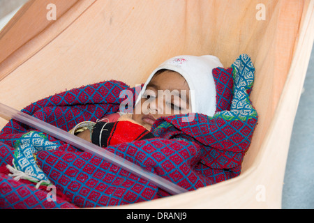 A baby in a hammock in Rajasthan, India. Stock Photo