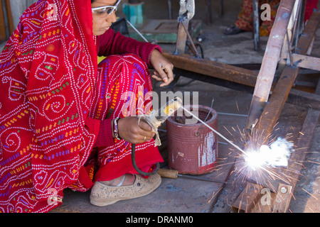 Women welding joints during the construction of solar cookers at the Barefoot College in Tilonia, Rajasthan, India. Stock Photo