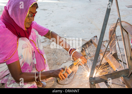 Women welding joints during the construction of solar cookers at the Barefoot College in Tilonia, Rajasthan, India. Stock Photo