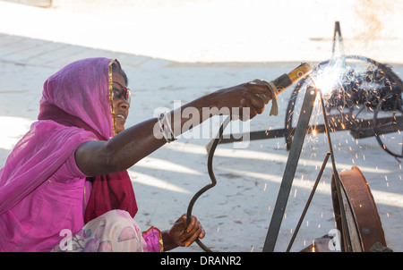 Women welding joints during the construction of solar cookers at the Barefoot College in Tilonia, Rajasthan, India. Stock Photo