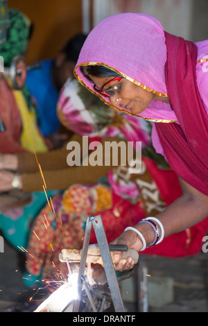 Women welding joints during the construction of solar cookers at the Barefoot College in Tilonia, Rajasthan, India. Stock Photo