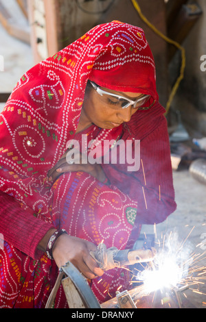 Women welding joints during the construction of solar cookers at the Barefoot College in Tilonia, Rajasthan, India. Stock Photo