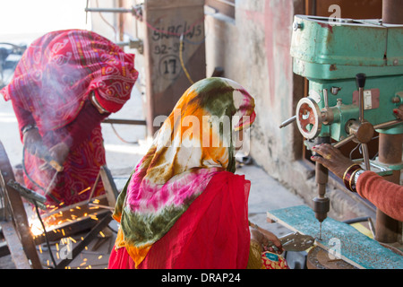 Women welding joints during the construction of solar cookers at the Barefoot College in Tilonia, Rajasthan, India. Stock Photo