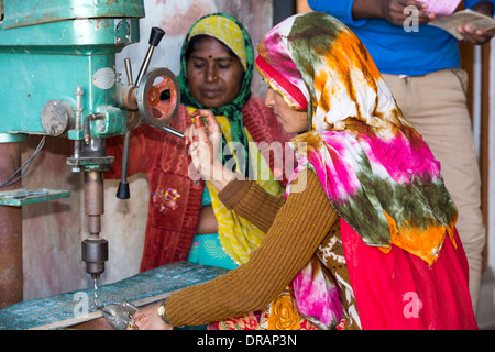 Women building solar cookers at the Barefoot College in Tilonia, Rajasthan, India. Stock Photo