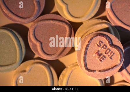 Love heart sweets with spoil me message showing Stock Photo