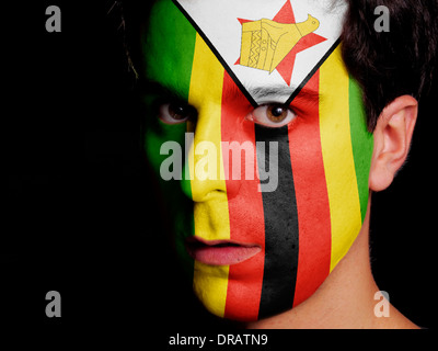 Flag of Zimbabwe Painted on a Face of a Young Man Stock Photo