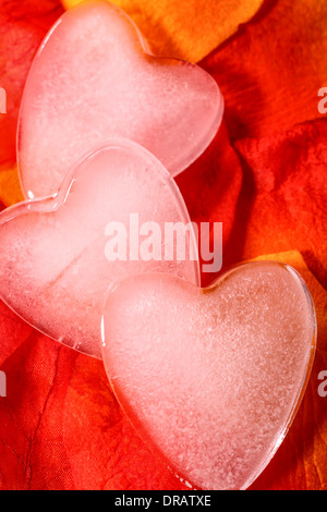 Ice shaped hearts on artificial rose petals Stock Photo