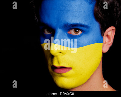 Flag of Ukraine Painted on a Face of a Young Man Stock Photo