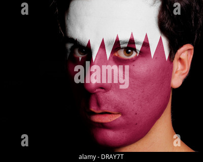 Flag of Qatar Painted on a Face of a Young Man Stock Photo