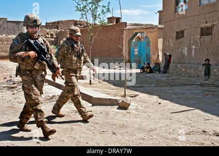 U.S. soldier patrols with his interpreter through Nowdeh Village, Afghanistan Stock Photo