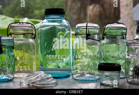 Empty glass jars sitting on a window shelf, waiting to be filled.