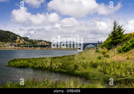 Isaac Lee Patterson bridge across the Rogue River with cloudy sky.  Gold Beach. Oregon Stock Photo