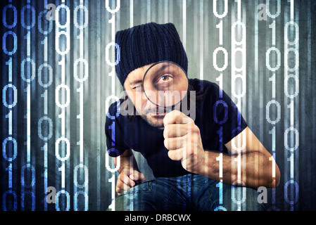 Man looking through magnifying glass and inspecting binary code Stock Photo