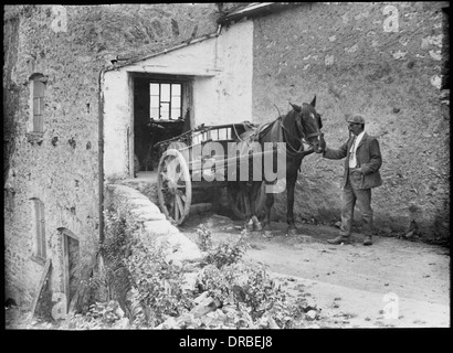 Miller George Newsham with a horse and cart at Beetham Mill in 1906. Cumbria (then Westmorland), Lake District, England. Reproduced from a glass lantern slide. Stock Photo