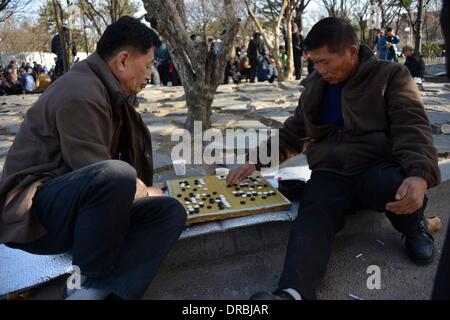 Two Korean men play baduk, also know as the Chinese Go game, outside the Gyeongbok Palace in Seoul, South Korea, 27 March 2013. In favorable weather, hundreds meet daily on the square outside the palace to meet up to play or watch players compete in baduk, chess and other games. Stock Photo