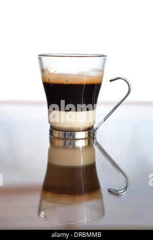 Cafe Bombon. Black coffee served with condensed milk in a glass. Stock Photo