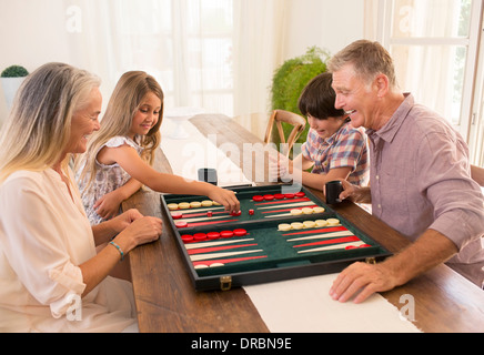 Grandparents and grandchildren playing backgammon Stock Photo