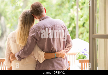 Senior couple hugging in doorway Stock Photo