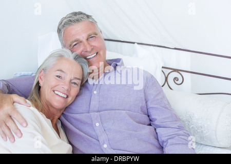 Senior couple laying on bed Stock Photo