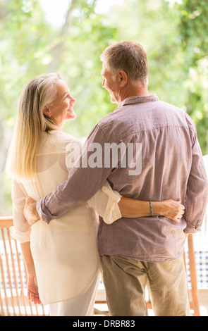 Senior couple hugging on patio Stock Photo