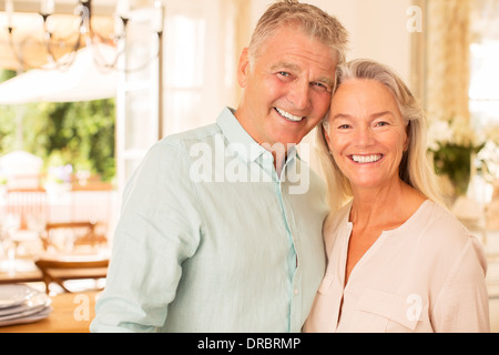 Older couple smiling indoors Stock Photo
