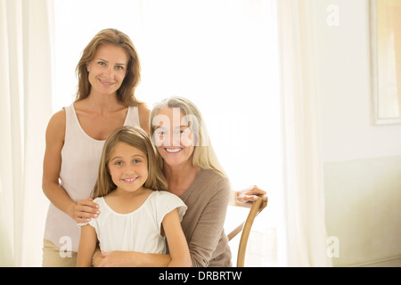 Multi-generation women smiling at window Stock Photo
