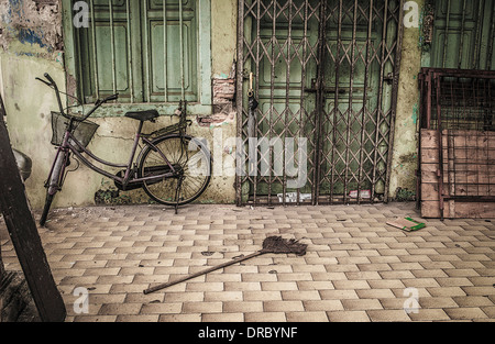 Ramshackle building with metal door and window grilles, in need of decoration. Stock Photo