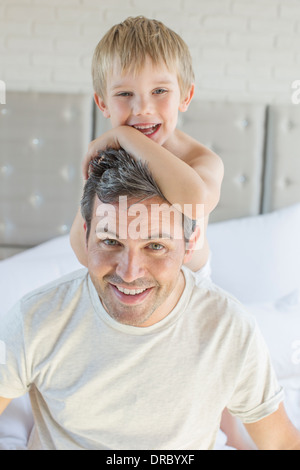 Father and son hugging on bed Stock Photo