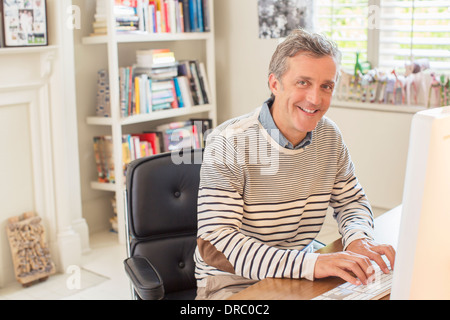 Man working at computer in home office Stock Photo