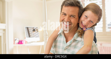 Father and daughter hugging in bedroom Stock Photo