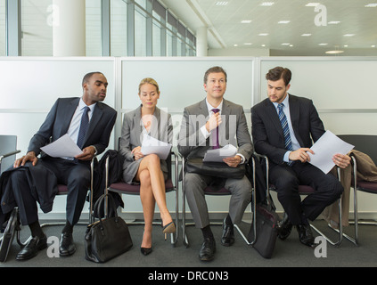 Business people sitting in waiting area Stock Photo
