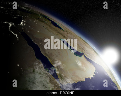 Sunrise over Arabian peninsula viewed from space. Highly detailed planet surface with clouds and city lights. Elements of this image furnished by NASA. Stock Photo