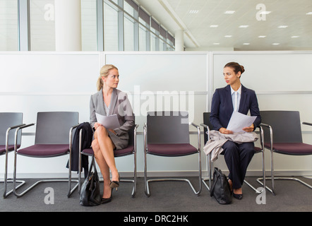 Businesswomen sitting in waiting area Stock Photo