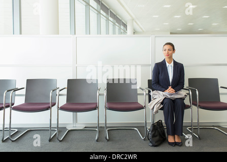 Businesswoman sitting in waiting area Stock Photo