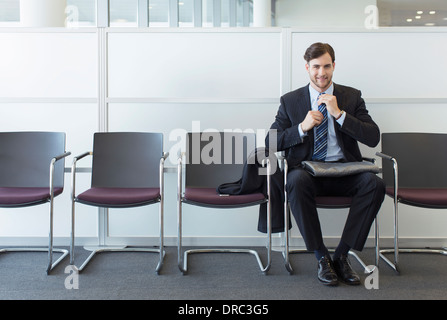 Businessman sitting in waiting area Stock Photo