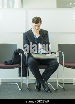 Businessman sitting in waiting area Stock Photo