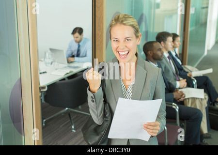 Businesswoman cheering in office Stock Photo