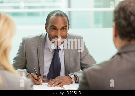 Businessman taking notes in meeting Stock Photo