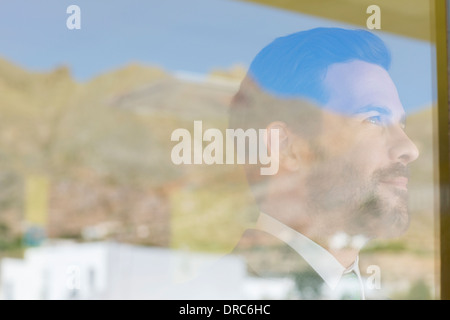 Businessman looking out window Stock Photo