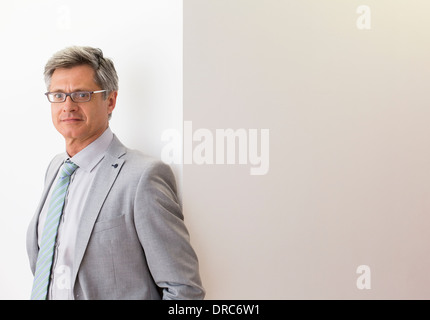 Businessman smiling in office Stock Photo