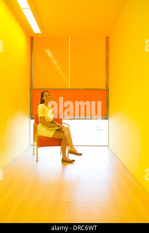 Businesswoman sitting in bright office Stock Photo