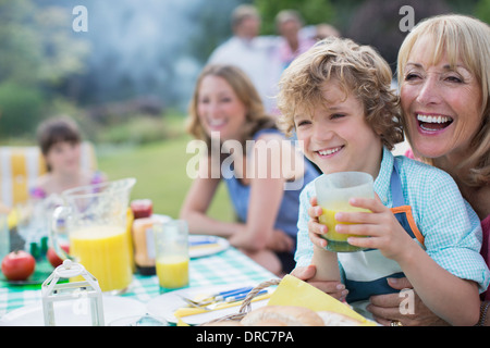 Family eating together outdoors Stock Photo