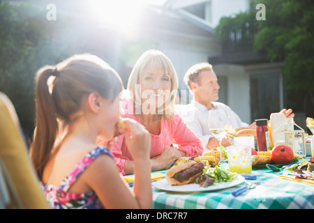 Family eating lunch at patio table Stock Photo
