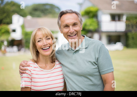 Smiling senior couple hugging outdoors Stock Photo
