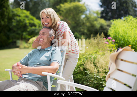 Senior couple relaxing in backyard Stock Photo
