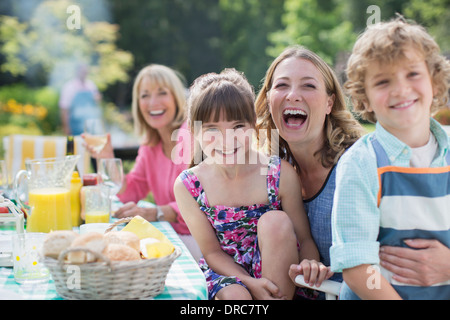 Family at table in backyard Stock Photo