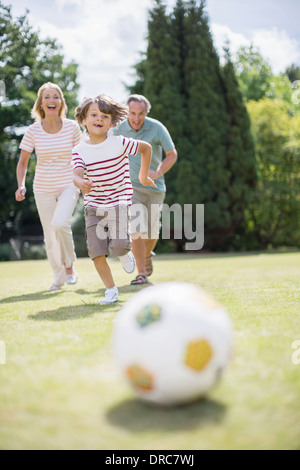 Grandparents and grandson playing soccer Stock Photo