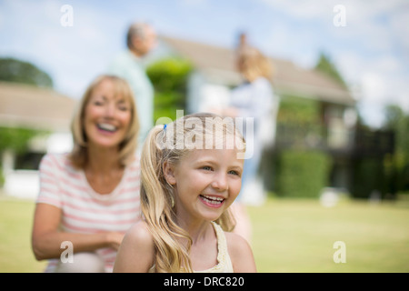 Grandmother and granddaughter smiling outdoors Stock Photo