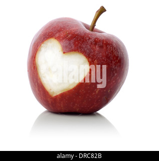 concept for loving healthy food, an apple with a heart symbol carved into it isolated on a white background Stock Photo